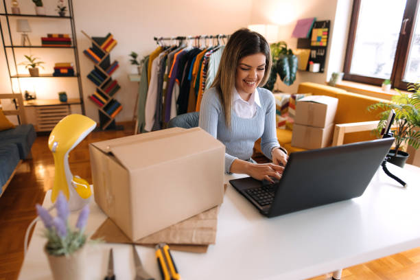 Young woman runs online clothing business from home office